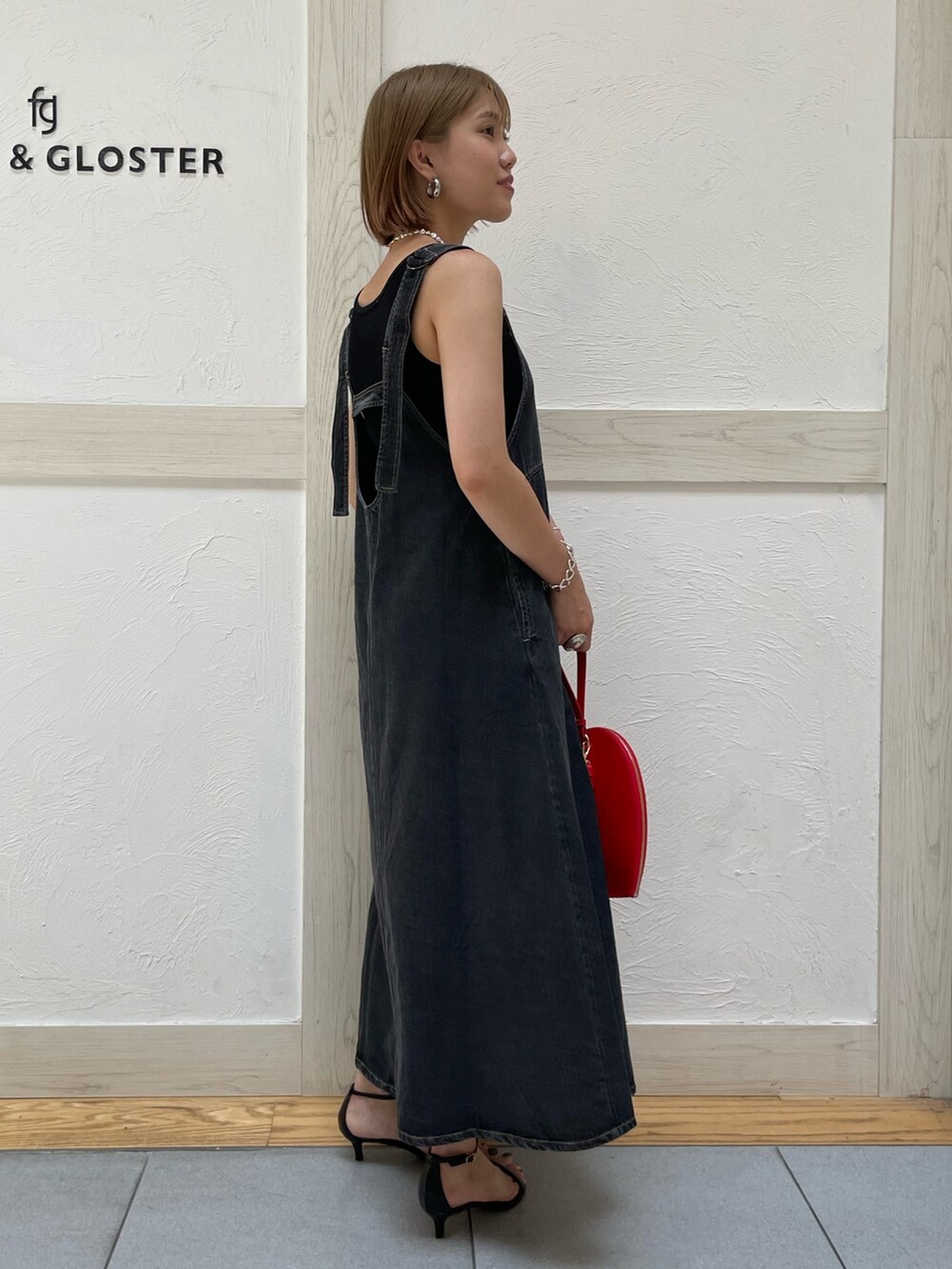 ブラック系のTシャツ/カットソー、ブラック系のワンピース、ピンク系のショルダーバッグを着用したレディースの夏コーディネートの2枚目の写真