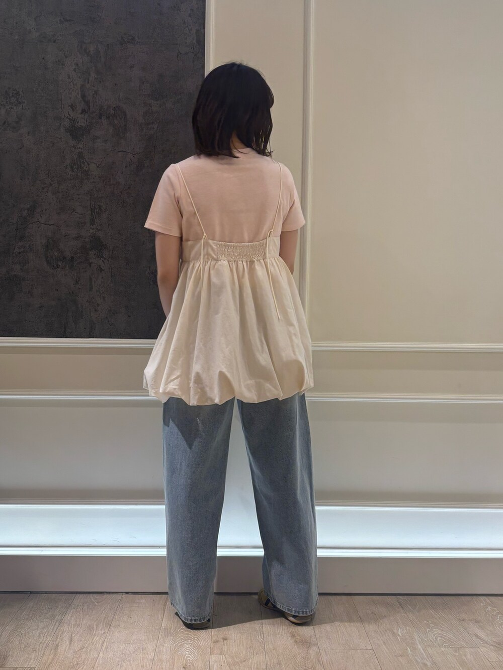 ブルー系のデニムパンツ、ピンク系のTシャツ/カットソー、ホワイト系のキャミソールを着用したレディースの春コーディネートの2枚目の写真