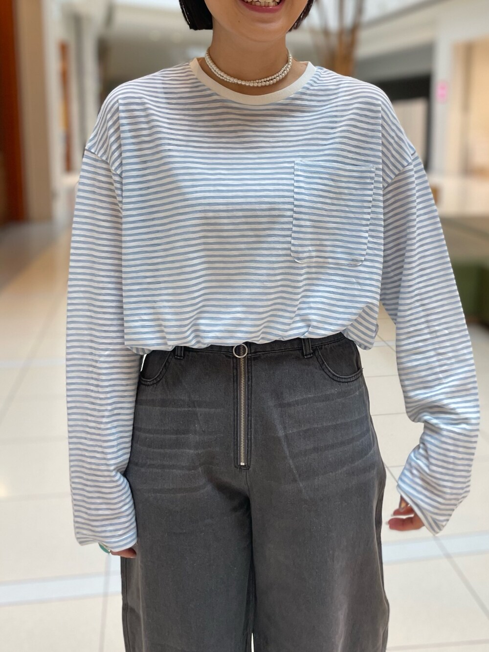 ブルー系のTシャツ/カットソー、ブラック系のデニムパンツを着用したレディースの春コーディネートの5枚目の写真