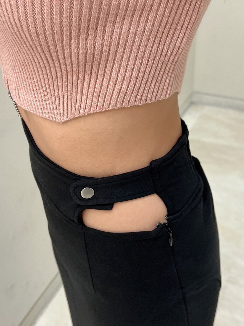 ブラック系のスカート、ピンク系のニット/セーター、ブラック系のパンプスを着用したレディースの冬コーディネートの7枚目の写真