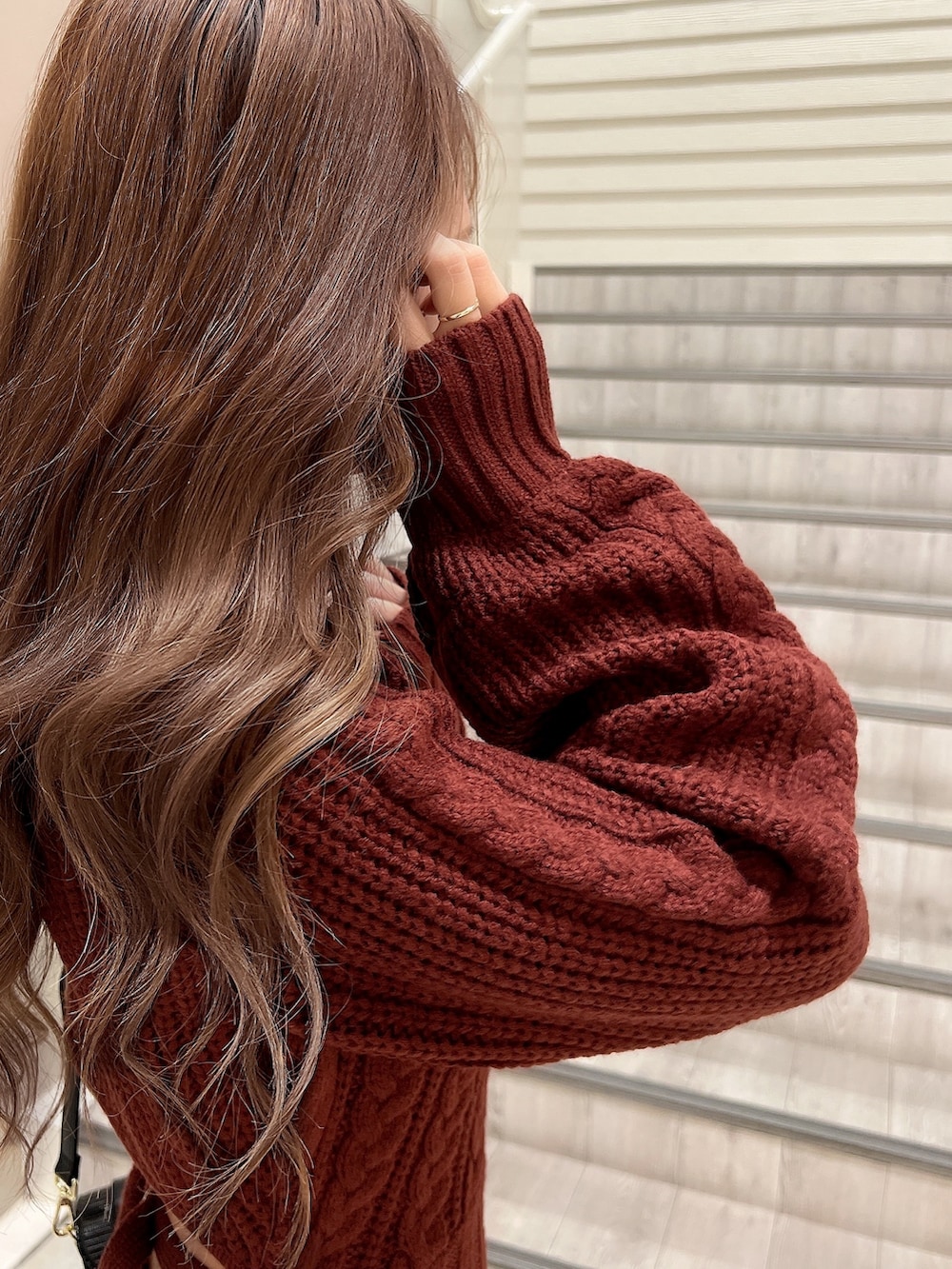 ブラック系のパンプス、ブラック系のショルダーバッグ、レッド系のワンピースを着用したレディースの秋コーディネートの6枚目の写真