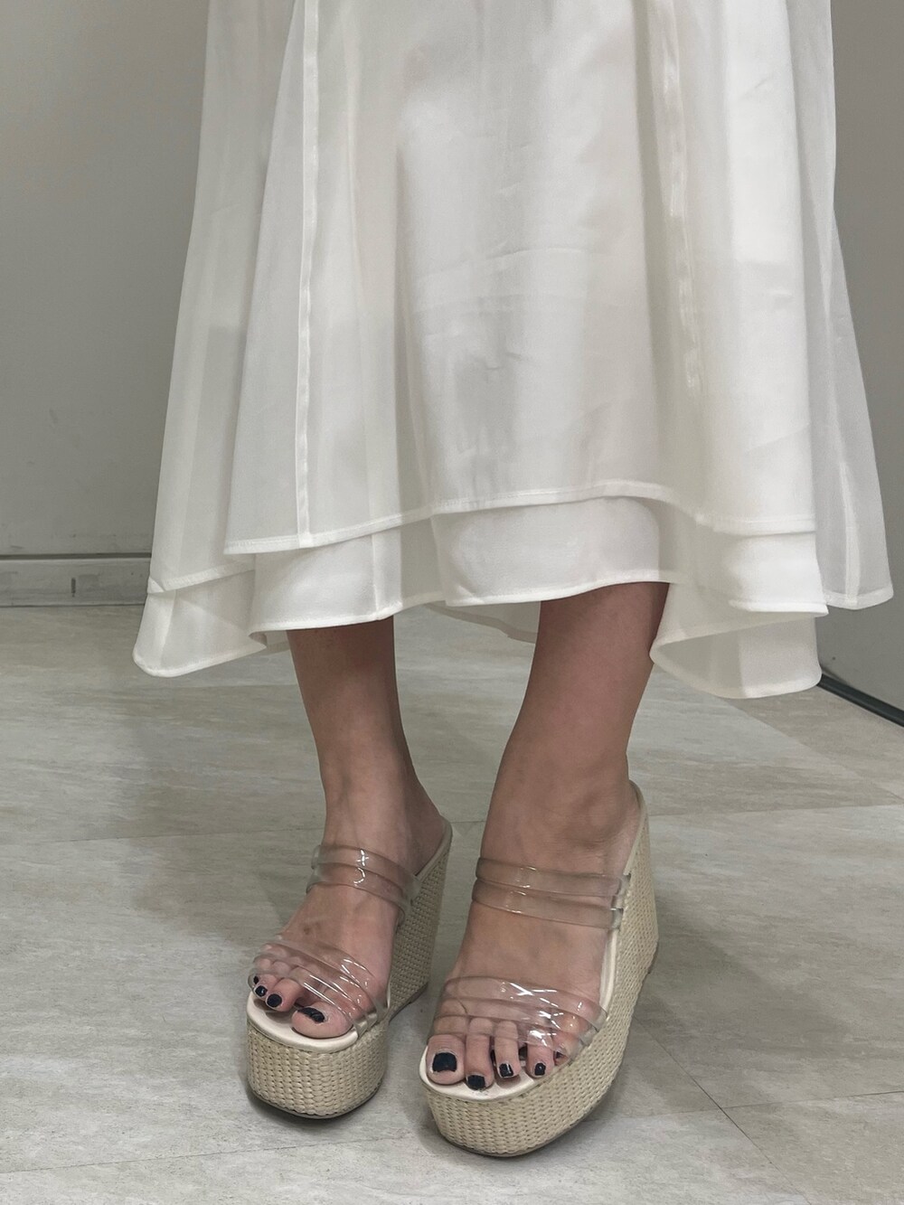 イエロー系のシャツ/ブラウス、ホワイト系のスカート、イエロー系のハンドバッグを着用したレディースの春コーディネートの8枚目の写真