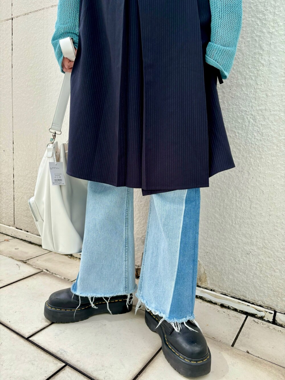 ブルー系のスカート、ブルー系のデニムパンツ、ブルー系のタンクトップを着用したレディースの春コーディネートの8枚目の写真