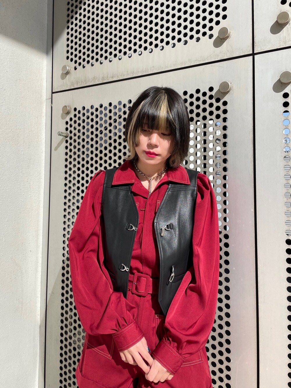 ブラック系のブーツ、ブラック系のベスト、レッド系のつなぎ/オールインワンを着用したレディースの春コーディネートの8枚目の写真