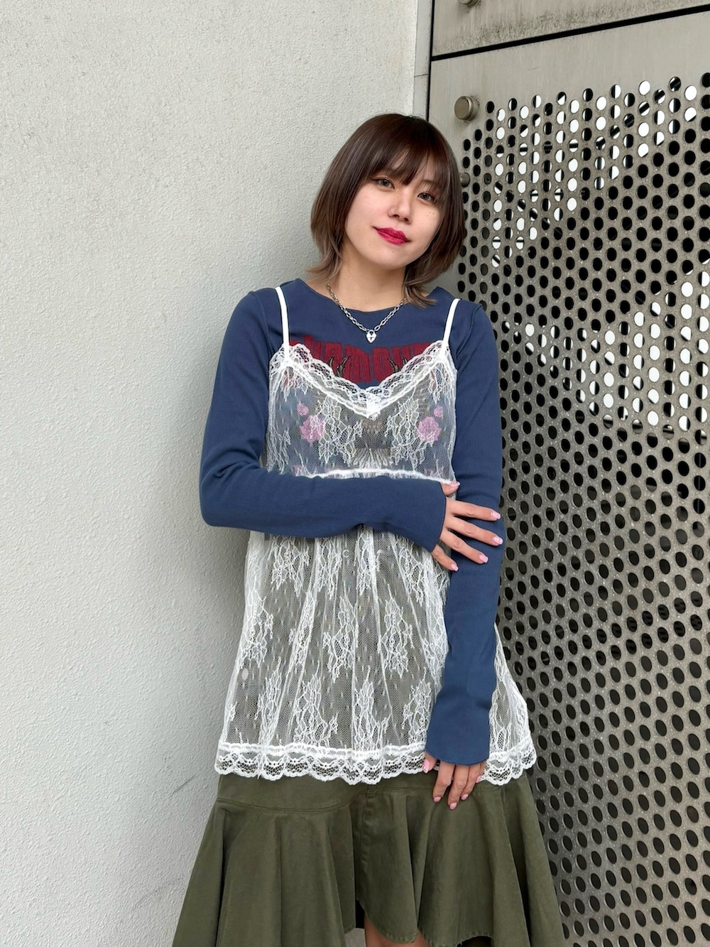 グリーン系のスカート、ブルー系のTシャツ/カットソー、ホワイト系のキャミソールを着用したレディースの冬コーディネートの7枚目の写真