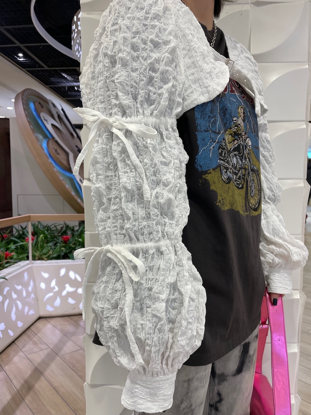 ブラック系のTシャツ/カットソー、ピンク系のショルダーバッグ、ホワイト系のカーディガン/ボレロを着用したレディースの冬コーディネートの6枚目の写真