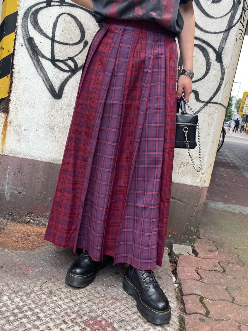 ブラック系のショルダーバッグ、ブラック系のTシャツ/カットソー、レッド系のスカートを着用したレディースの夏コーディネートの4枚目の写真