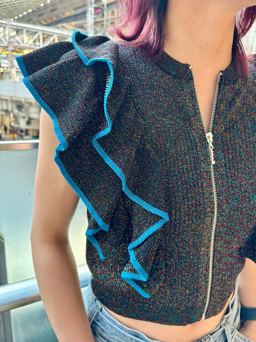 ブルー系のデニムパンツ、ブラック系のニット/セーター、シルバー系のブレスレットを着用したレディースの夏コーディネートの6枚目の写真