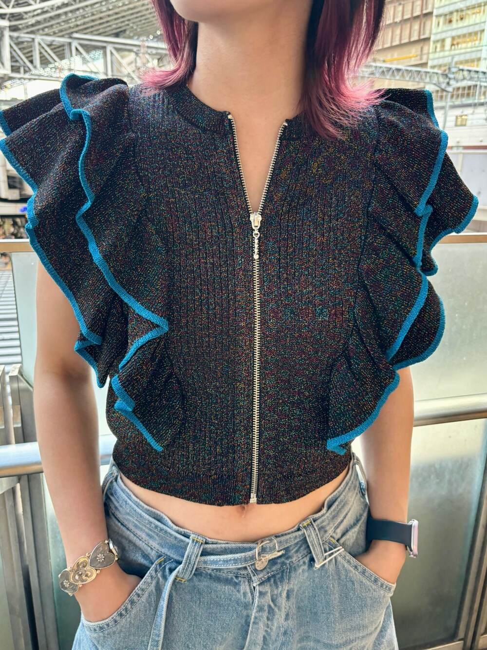 ブルー系のデニムパンツ、ブラック系のニット/セーター、シルバー系のブレスレットを着用したレディースの夏コーディネートの8枚目の写真