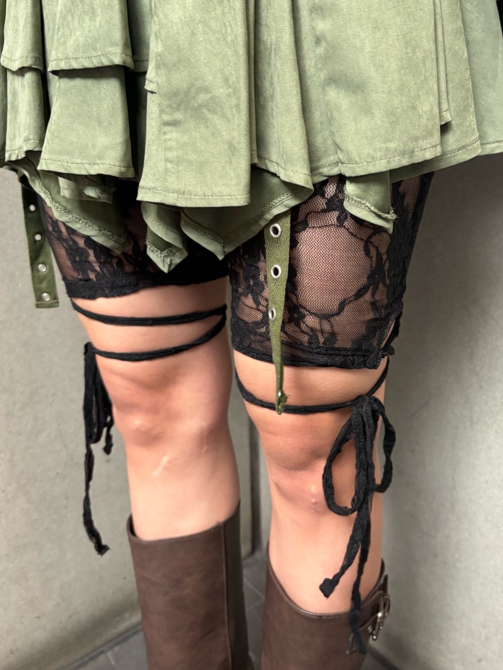 ブラック系のTシャツ/カットソー、ブラック系のカーディガン/ボレロ、グリーン系のスカートを着用したレディースの秋コーディネートの9枚目の写真