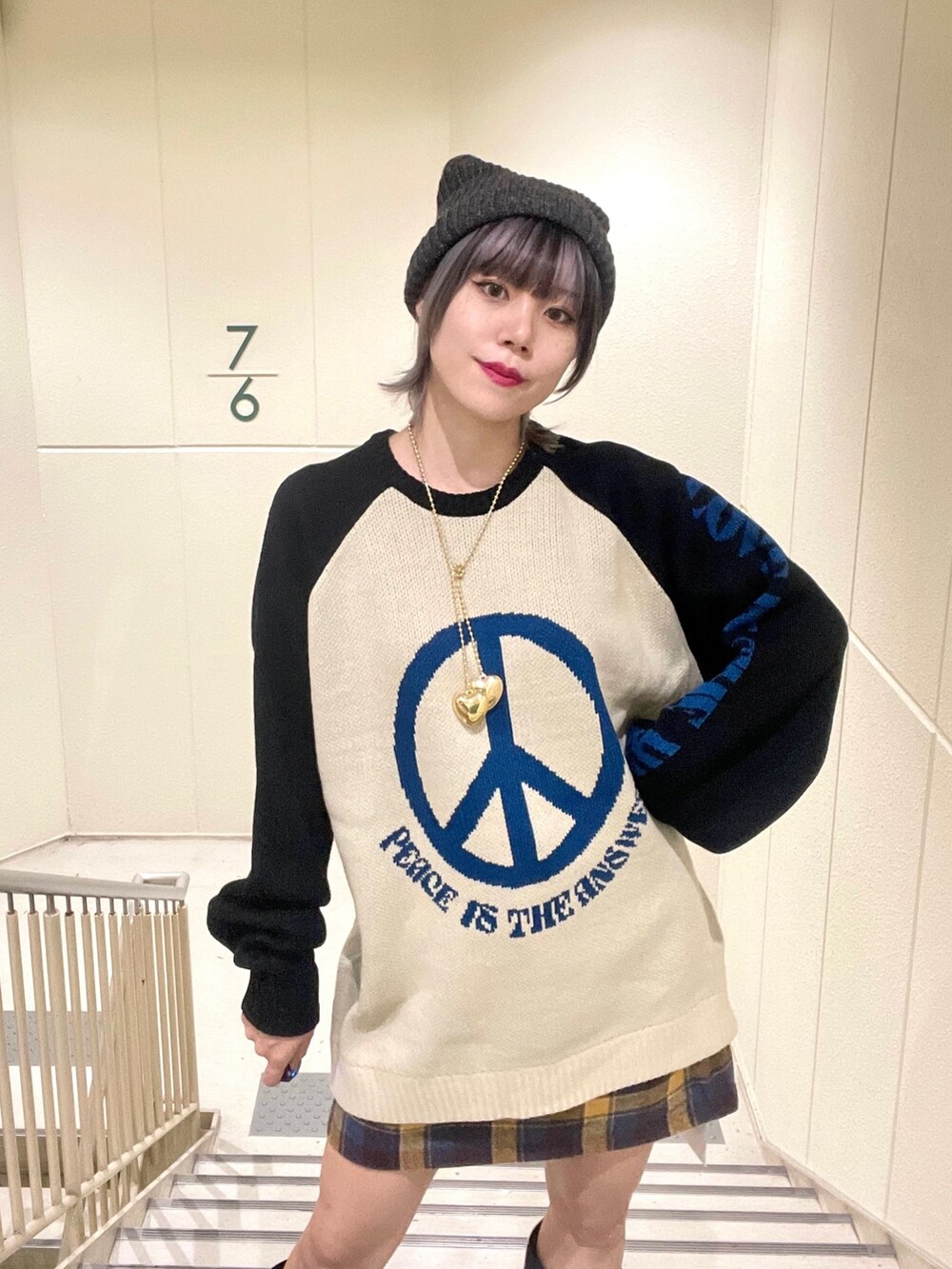 ブラック系のその他アウター、イエロー系のスカート、ホワイト系のブーツを着用したレディースの秋コーディネートの7枚目の写真