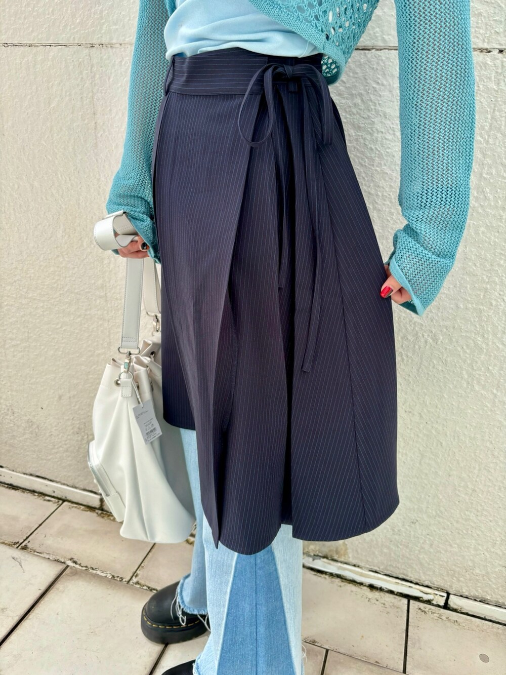 ブルー系のスカート、ブルー系のデニムパンツ、ブルー系のタンクトップを着用したレディースの春コーディネートの9枚目の写真