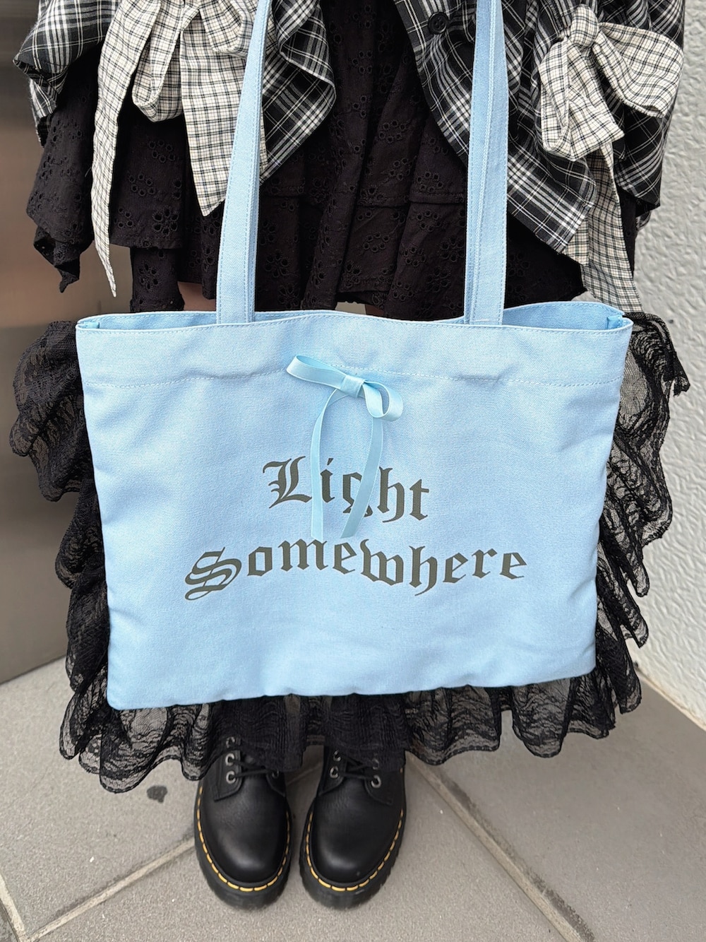 ブラック系のシャツ/ブラウス、ブルー系のトートバッグ、ブラック系のブーツを着用したレディースの冬コーディネートの8枚目の写真