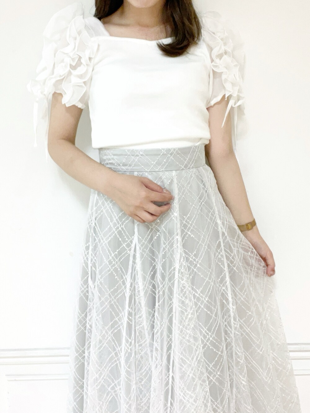 ホワイト系のTシャツ/カットソー、シルバー系のパンプス、グレー系のスカートを着用したレディースの夏コーディネートの3枚目の写真