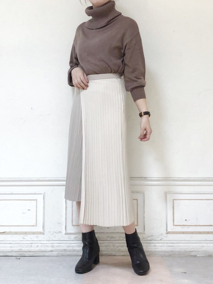 ベージュ系のスカート、ブラウン系のブーツ、ブラウン系のニット/セーターを着用したレディースの秋コーディネートの2枚目の写真