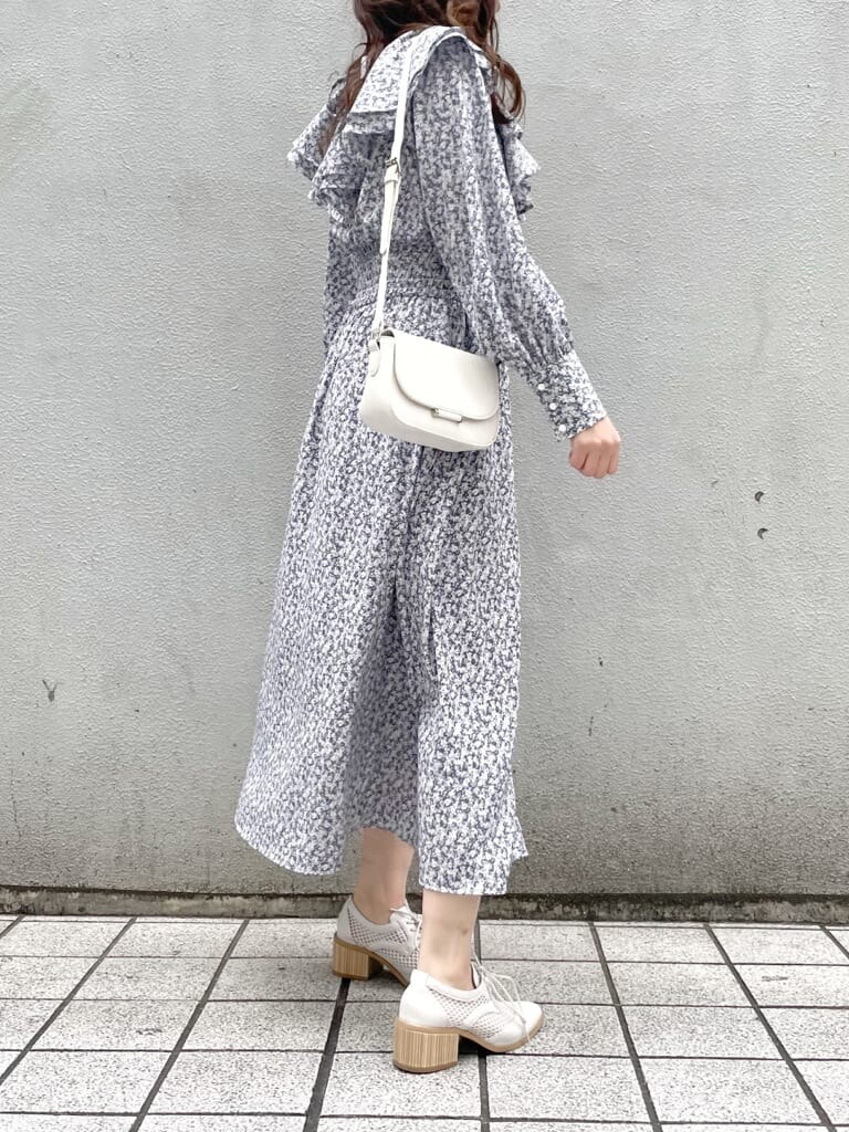 ブルー系のワンピース、ホワイト系のローファー、ホワイト系のショルダーバッグを着用したレディースの冬コーディネートの9枚目の写真