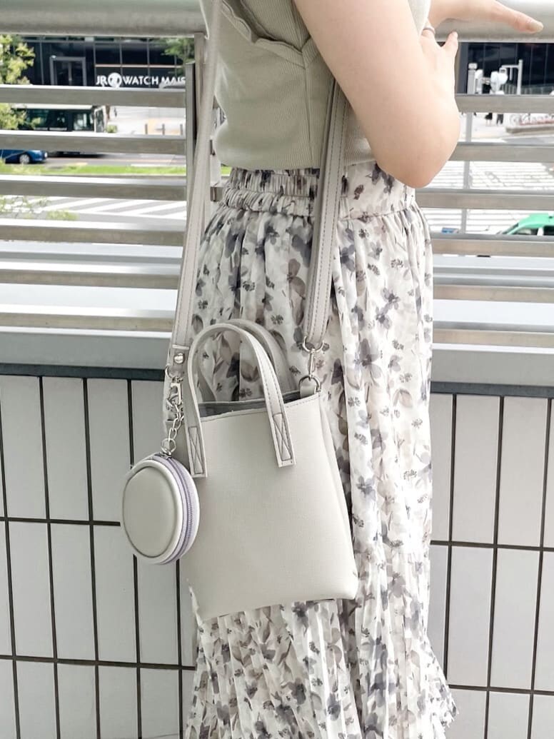 グレー系のハンドバッグ、その他のサンダル、グリーン系のTシャツ/カットソーを着用したレディースの夏コーディネートの7枚目の写真