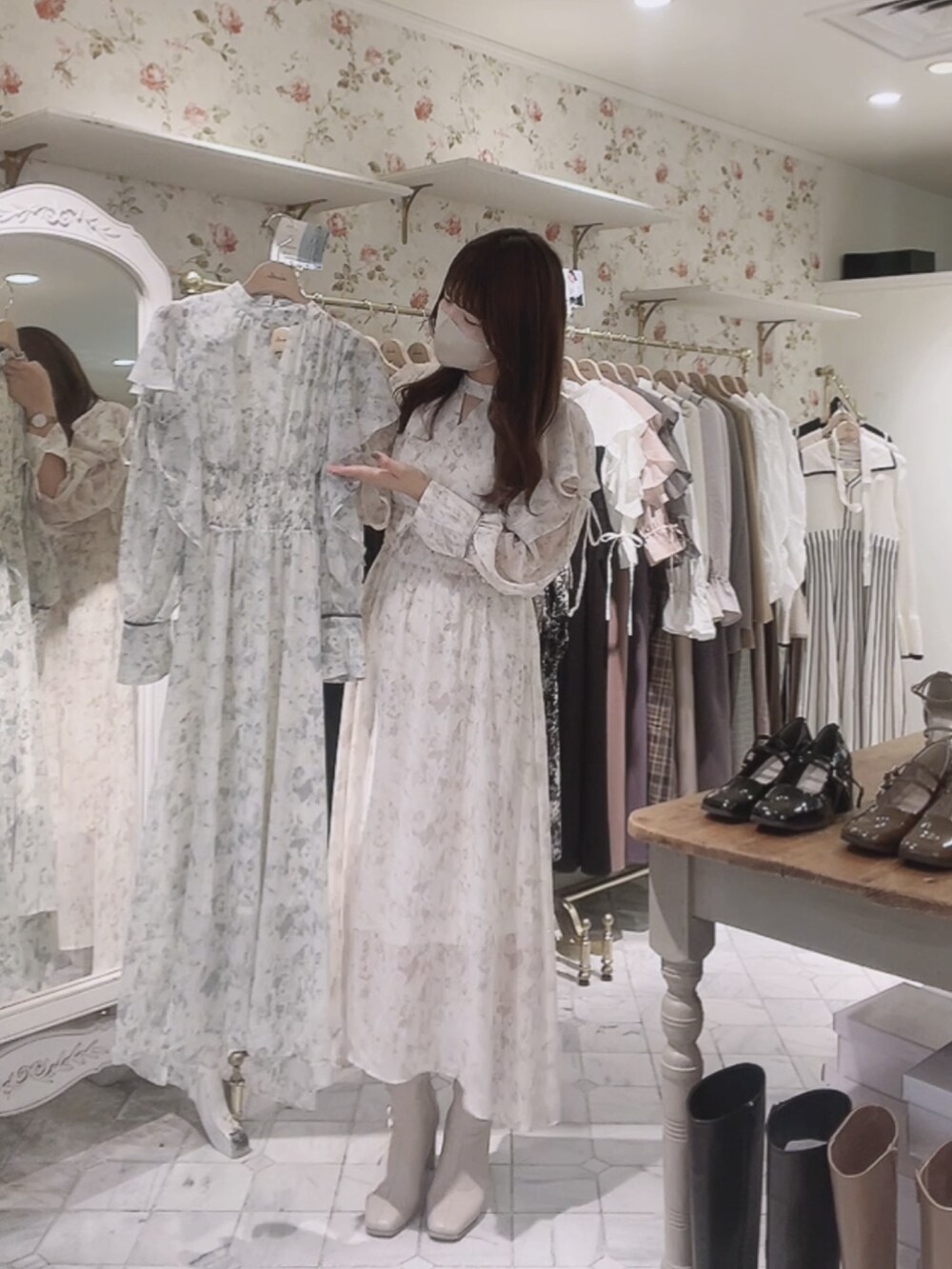 ホワイト系のワンピース、ホワイト系のカーディガン/ボレロ、ホワイト系のブーツを着用したレディースの秋コーディネートの5枚目の写真