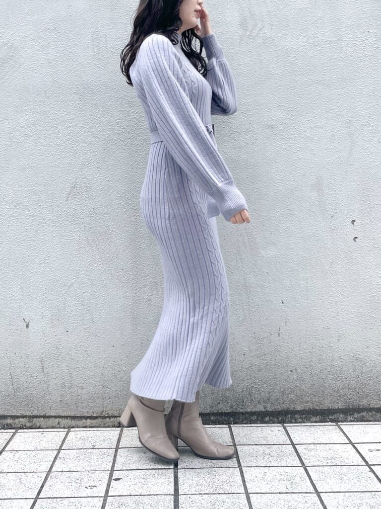 ベージュ系のブーツ、ブルー系のワンピースを着用したレディースの秋コーディネートの2枚目の写真