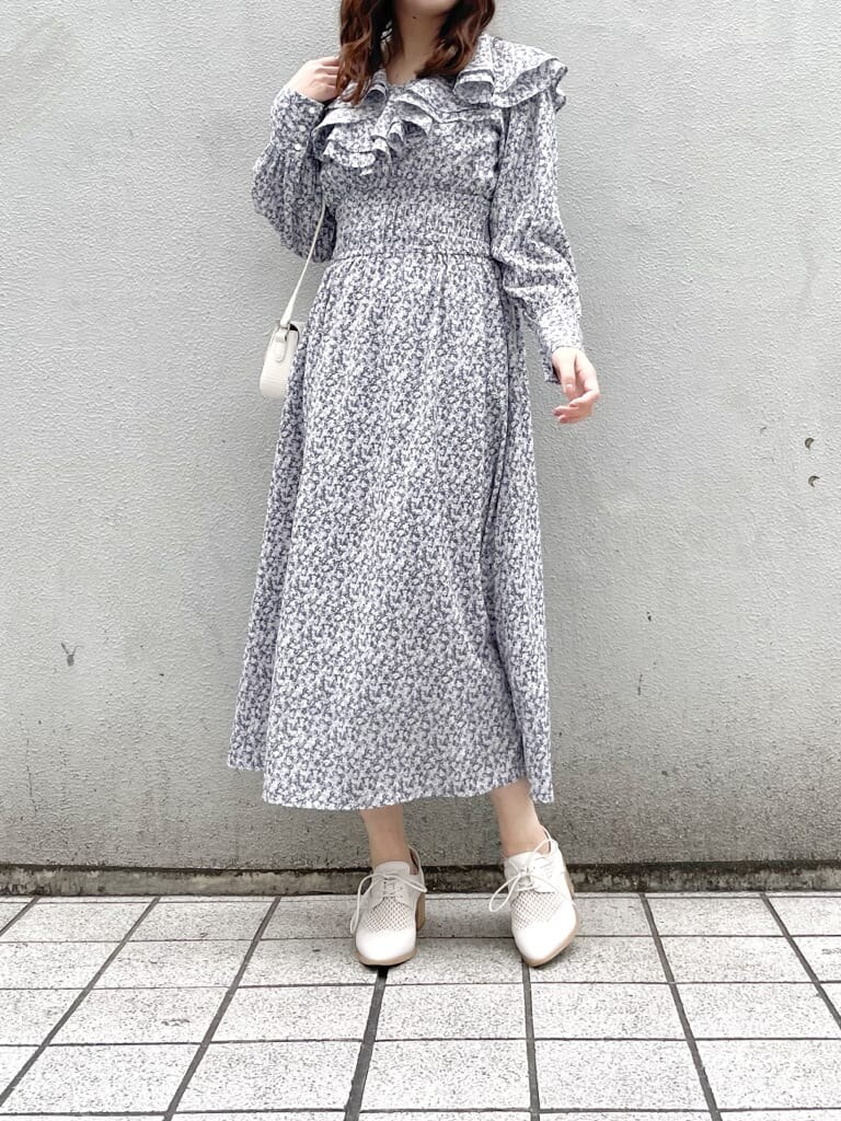 ブルー系のワンピース、ホワイト系のローファー、ホワイト系のショルダーバッグを着用したレディースの冬コーディネートの2枚目の写真