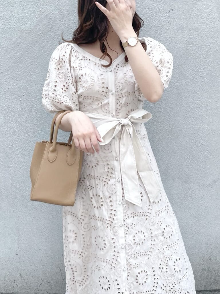 ホワイト系のワンピース、ベージュ系のハンドバッグ、ホワイト系のパンプスを着用したレディースの春コーディネートの4枚目の写真