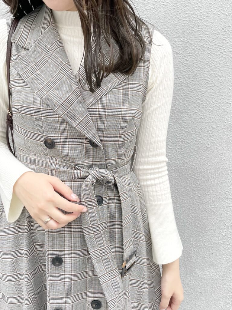 グレー系のワンピース、ホワイト系のニット/セーター、ホワイト系のパンプスを着用したレディースの秋コーディネートの6枚目の写真