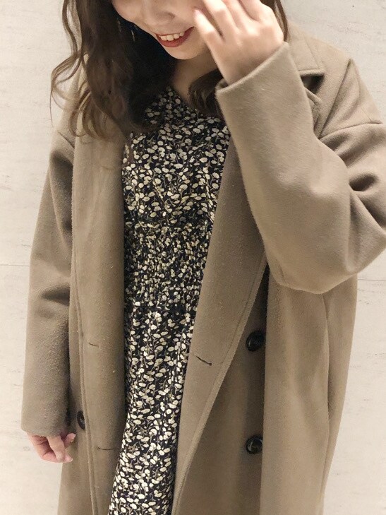 ホワイト系のブーツ、ベージュ系のその他アウター、ブラック系のワンピースを着用したレディースの冬コーディネートの3枚目の写真