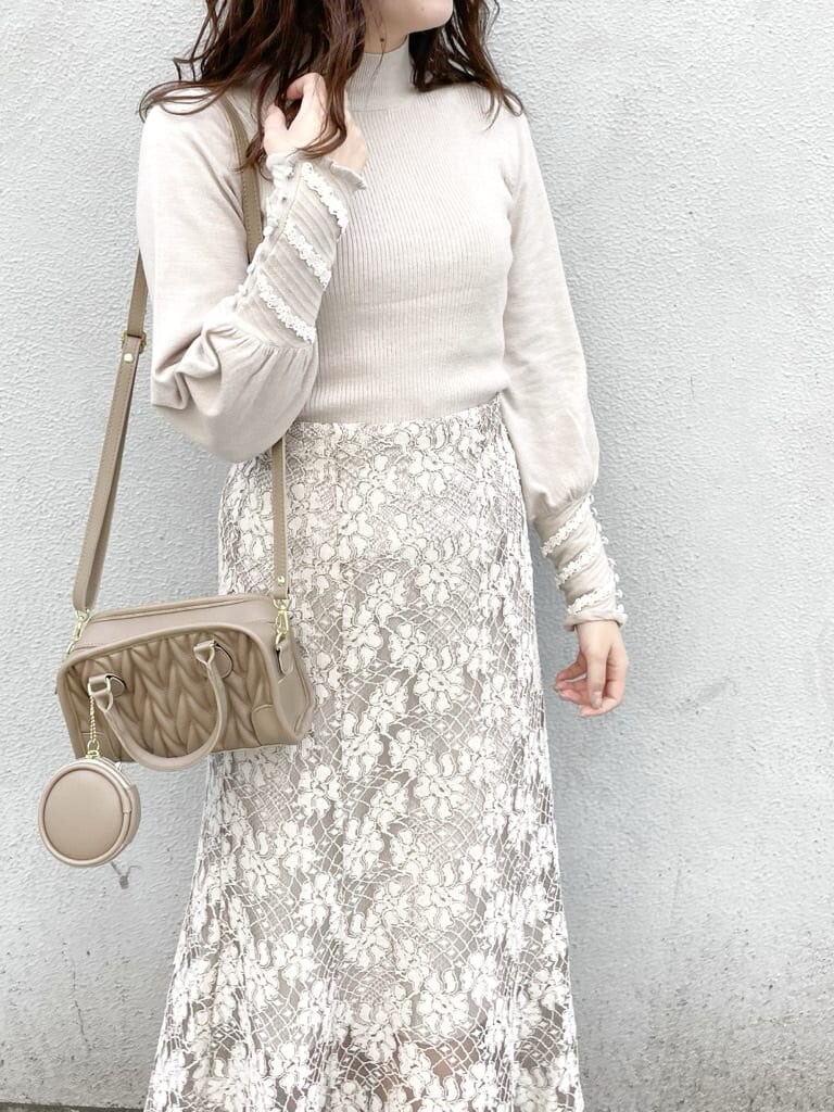 ベージュ系のスカート、ベージュ系のその他アウター、ベージュ系のハンドバッグを着用したレディースの秋コーディネートの8枚目の写真