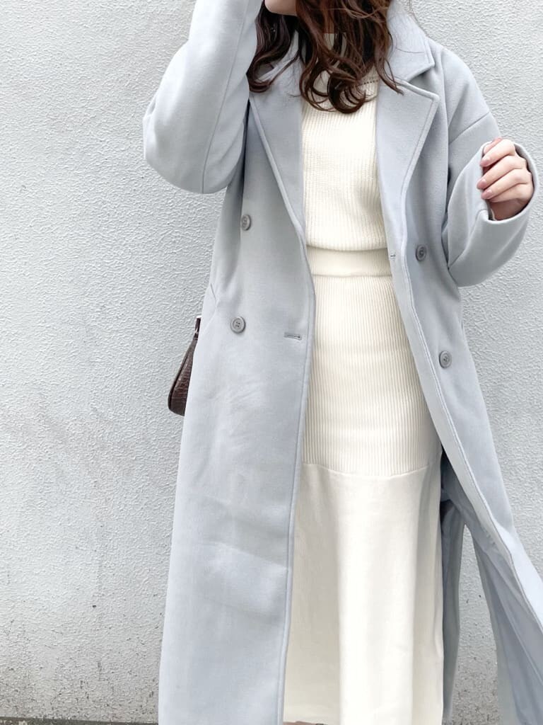 ベージュ系のブーツ、ホワイト系のワンピース、ブルー系のチェスターコートを着用したレディースの冬コーディネートの5枚目の写真