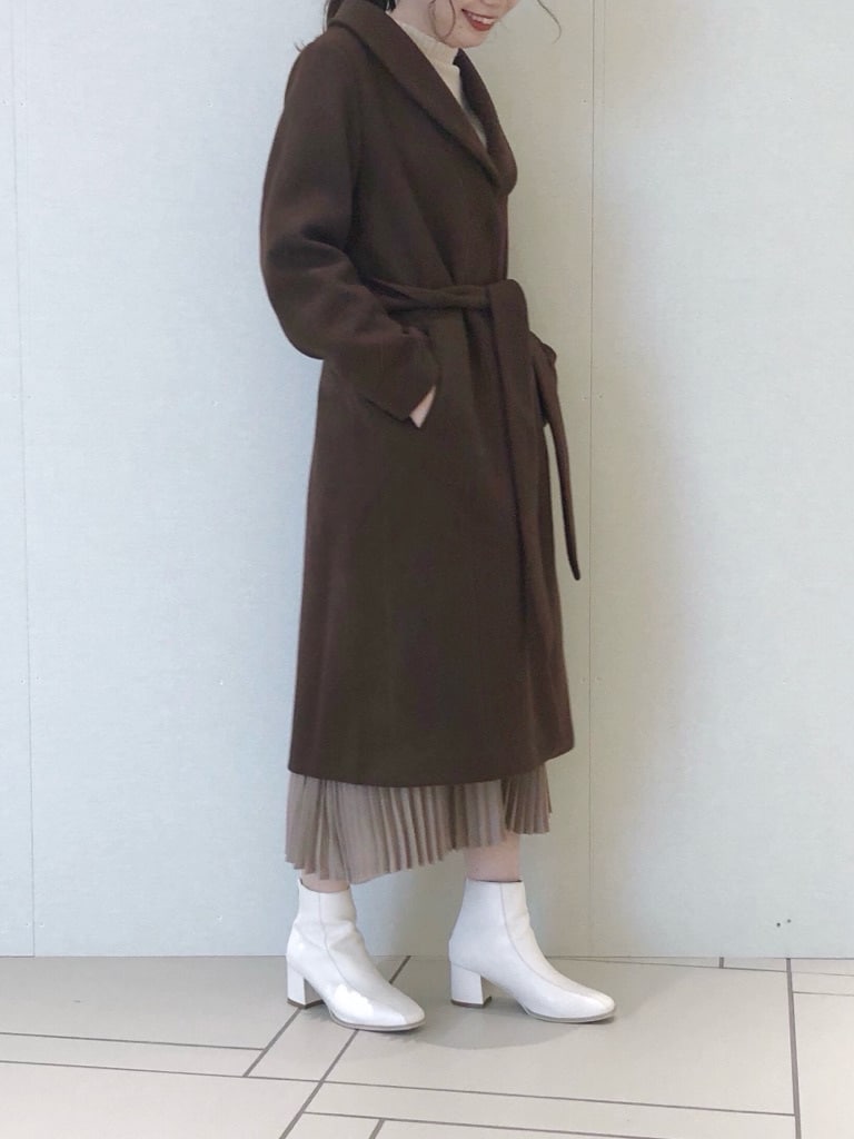 ベージュ系のワンピース、ホワイト系のブーツ、ブラウン系のその他アウターを着用したレディースの冬コーディネートの2枚目の写真