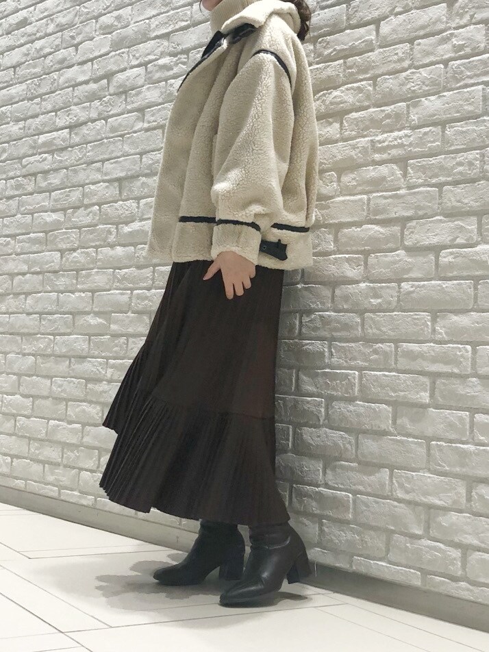 ホワイト系のニット/セーター、ホワイト系のブルゾン、ブラウン系のブーツを着用したレディースの冬コーディネートの4枚目の写真