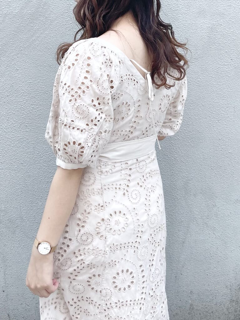 ホワイト系のワンピース、ベージュ系のハンドバッグ、ホワイト系のパンプスを着用したレディースの春コーディネートの6枚目の写真