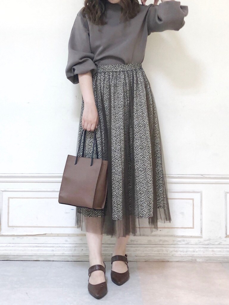 ブラウン系のパンプス、ベージュ系のTシャツ/カットソー、ブラウン系のスカートを着用したレディースの秋コーディネートの2枚目の写真