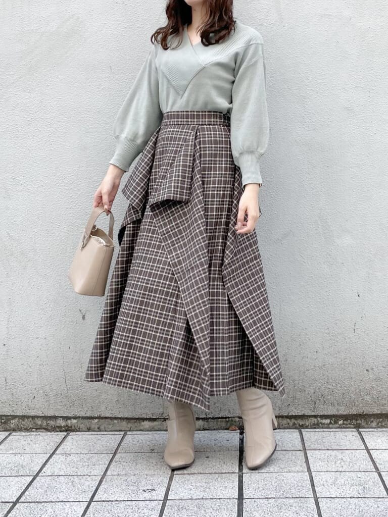 その他のスカート、ベージュ系のブーツ、グリーン系のニット/セーターを着用したレディースの秋コーディネートの2枚目の写真