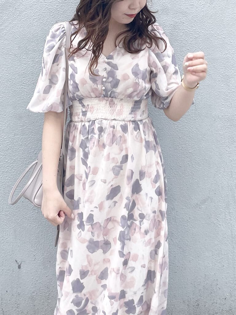 ピンク系のワンピース、ホワイト系のパンプス、ベージュ系のハンドバッグを着用したレディースの春コーディネートの3枚目の写真