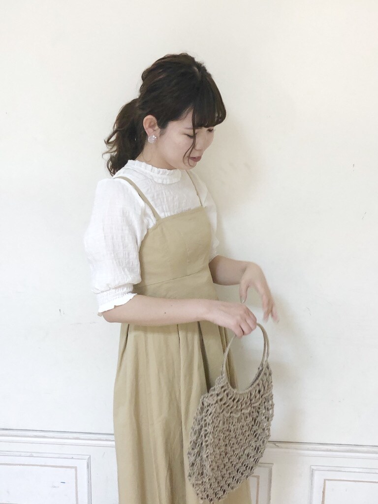 ベージュ系のワンピース、ホワイト系のシャツ/ブラウス、ホワイト系のパンプスを着用したレディースの春コーディネートの3枚目の写真