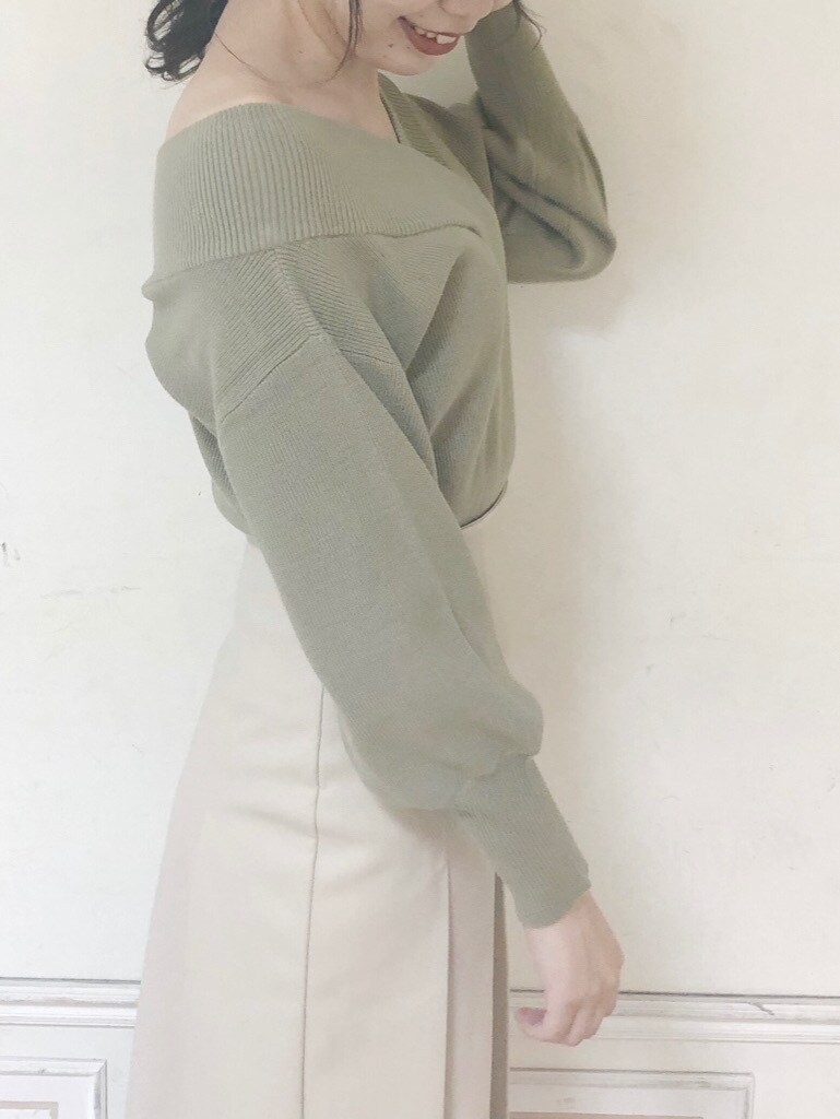 グリーン系のニット/セーター、ベージュ系のスカート、ブラウン系のブーツを着用したレディースの秋コーディネートの6枚目の写真