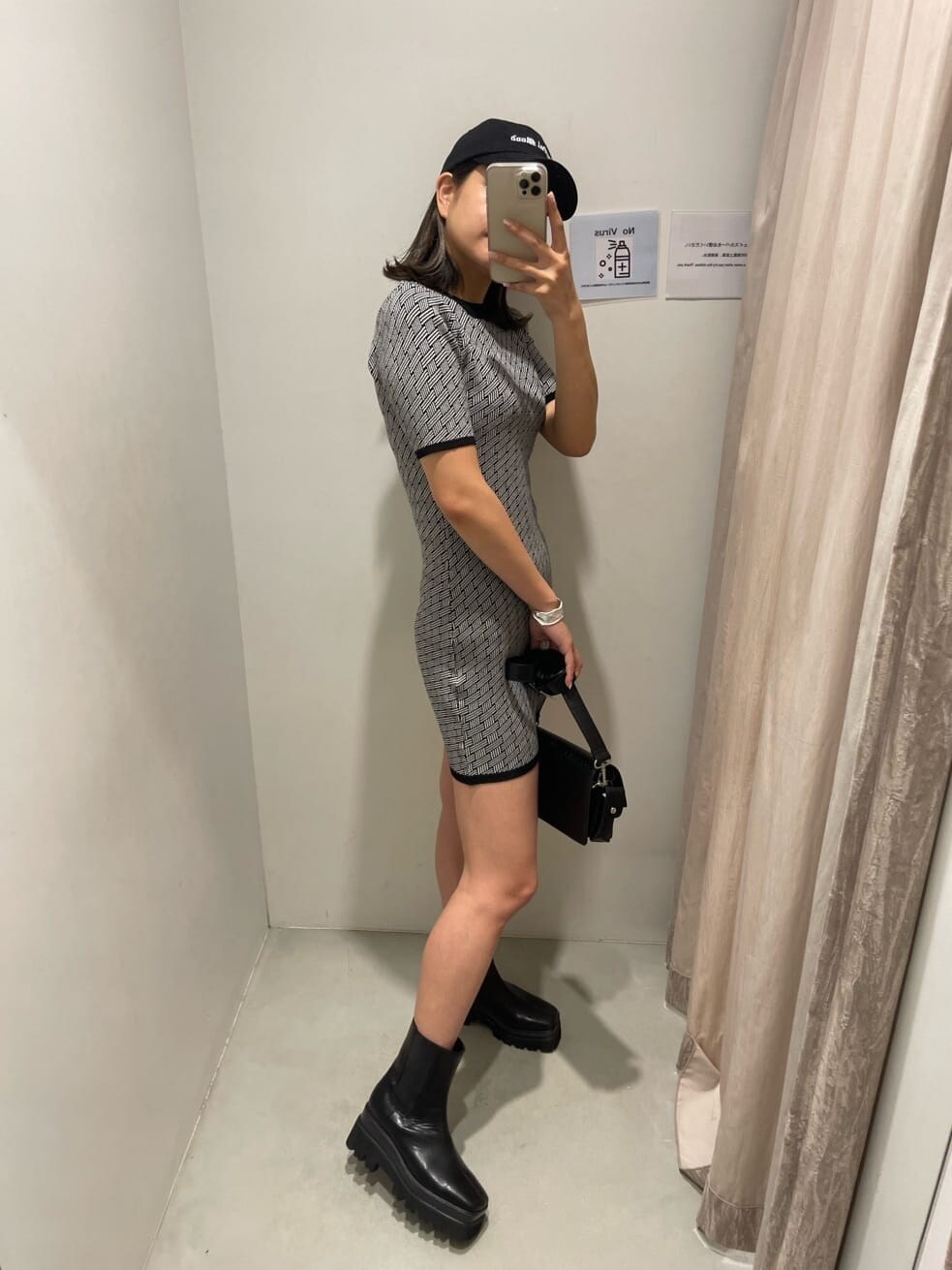 ブラック系のブーツ、ブラック系のワンピース、ブラック系のキャップを着用したレディースの夏コーディネートの3枚目の写真