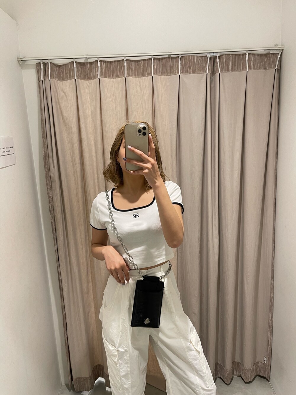 ホワイト系のカーゴパンツ、ブラック系のブーツ、ホワイト系のTシャツ/カットソーを着用したレディースの春コーディネートの5枚目の写真