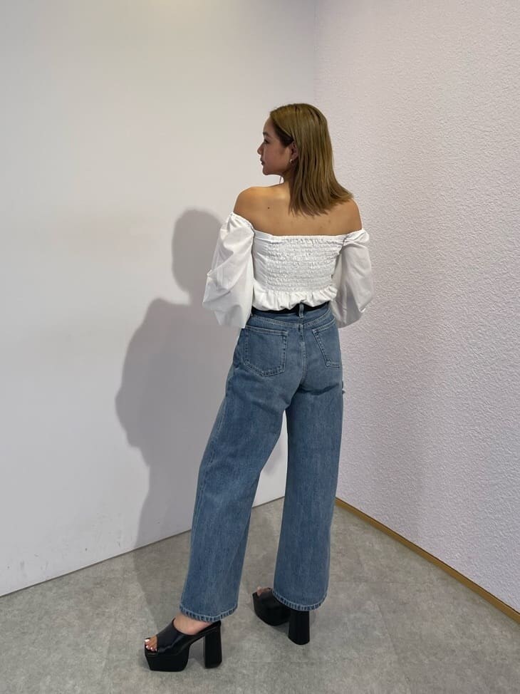 ブラック系のサンダル、ブラック系のボストンバッグ、ブルー系のデニムパンツを着用したレディースの夏コーディネートの2枚目の写真