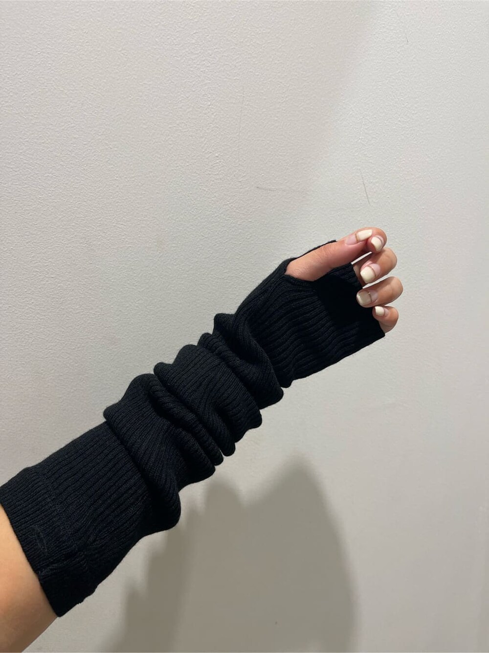 ブラック系のブーツ、ブラック系のワンピース、グリーン系のショルダーバッグを着用したレディースの秋コーディネートの5枚目の写真