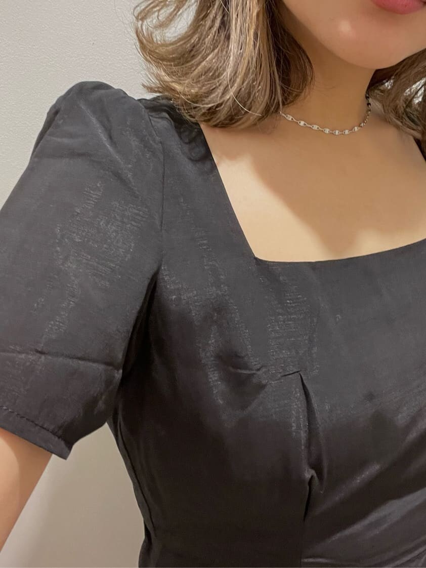 ブラック系のサンダル、ブラック系のワンピース、ホワイト系のショルダーバッグを着用したレディースの春コーディネートの3枚目の写真