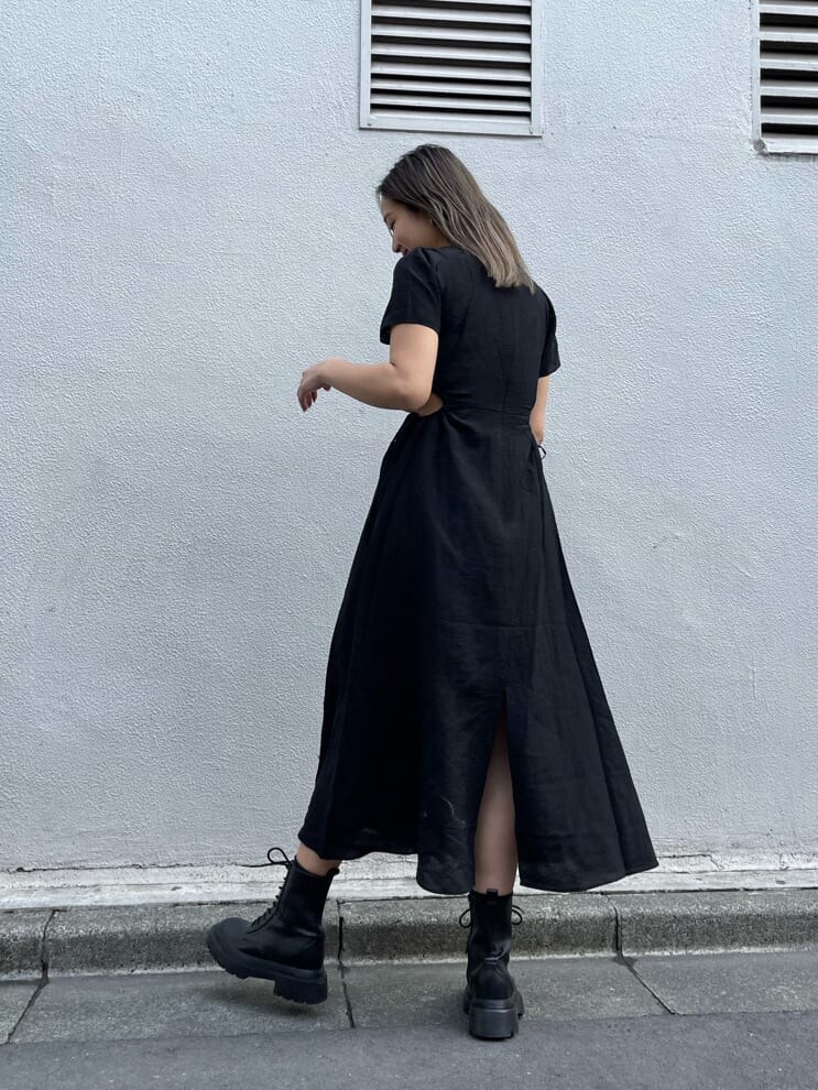 ブラック系のブーツ、グリーン系のショルダーバッグ、ブラック系のワンピースを着用したレディースの春コーディネートの3枚目の写真