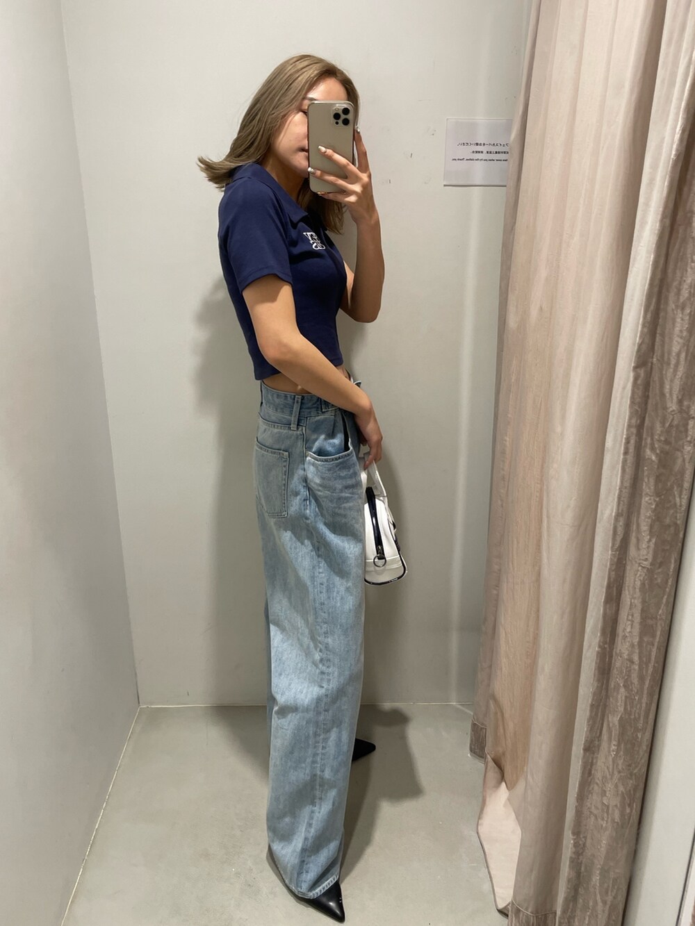 ブルー系のデニムパンツ、ブラック系のサンダル、ブルー系のTシャツ/カットソーを着用したレディースの春コーディネートの4枚目の写真