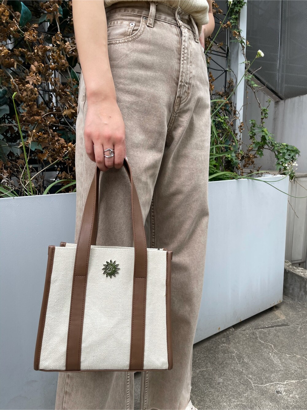 ベージュ系のデニムパンツ、ホワイト系のタンクトップ、ホワイト系のサンダルを着用したレディースの春コーディネートの7枚目の写真