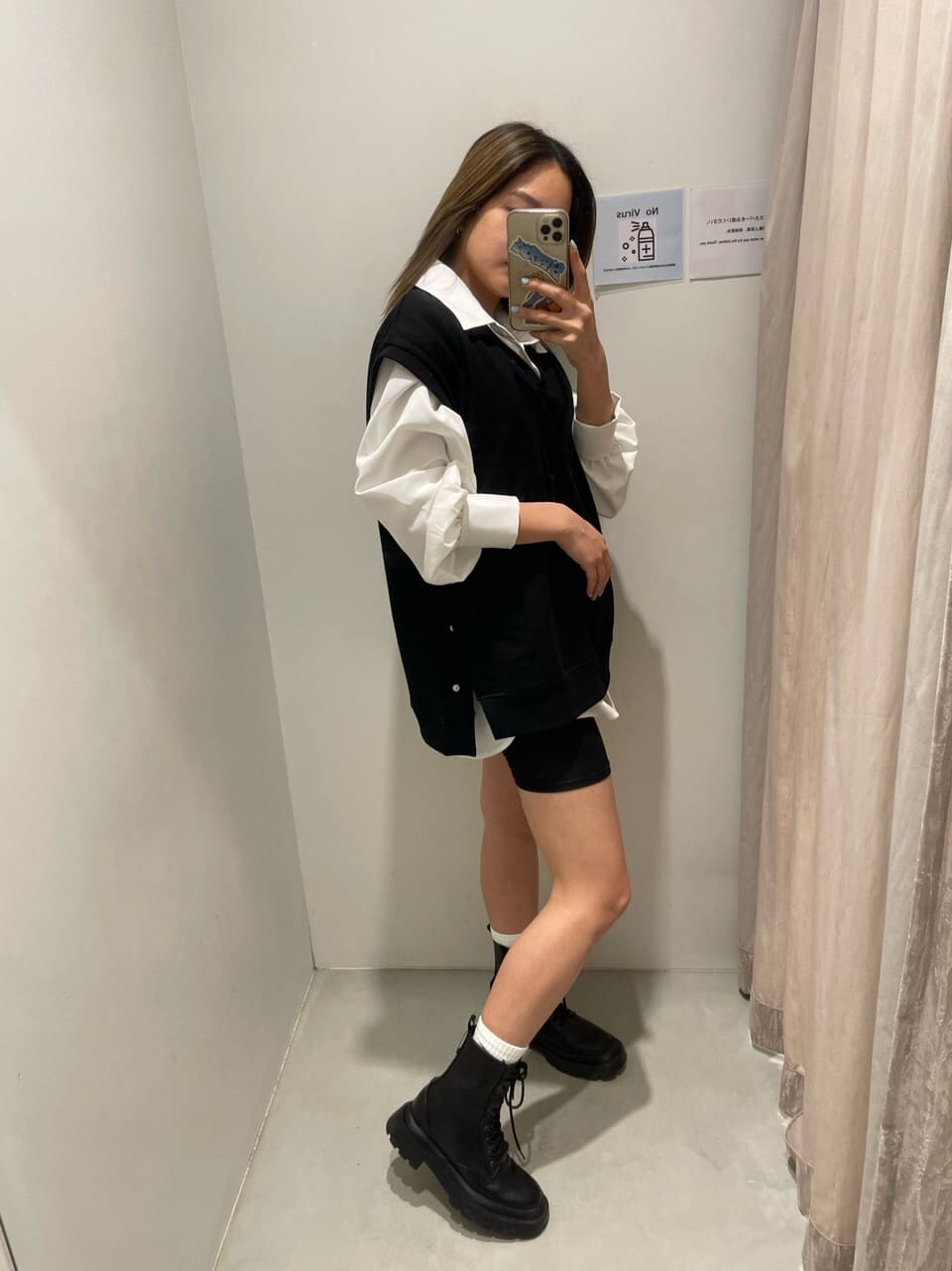 ホワイト系のシャツ/ブラウス、ブラック系のブーツ、ブラック系のベストを着用したレディースの春コーディネートの2枚目の写真