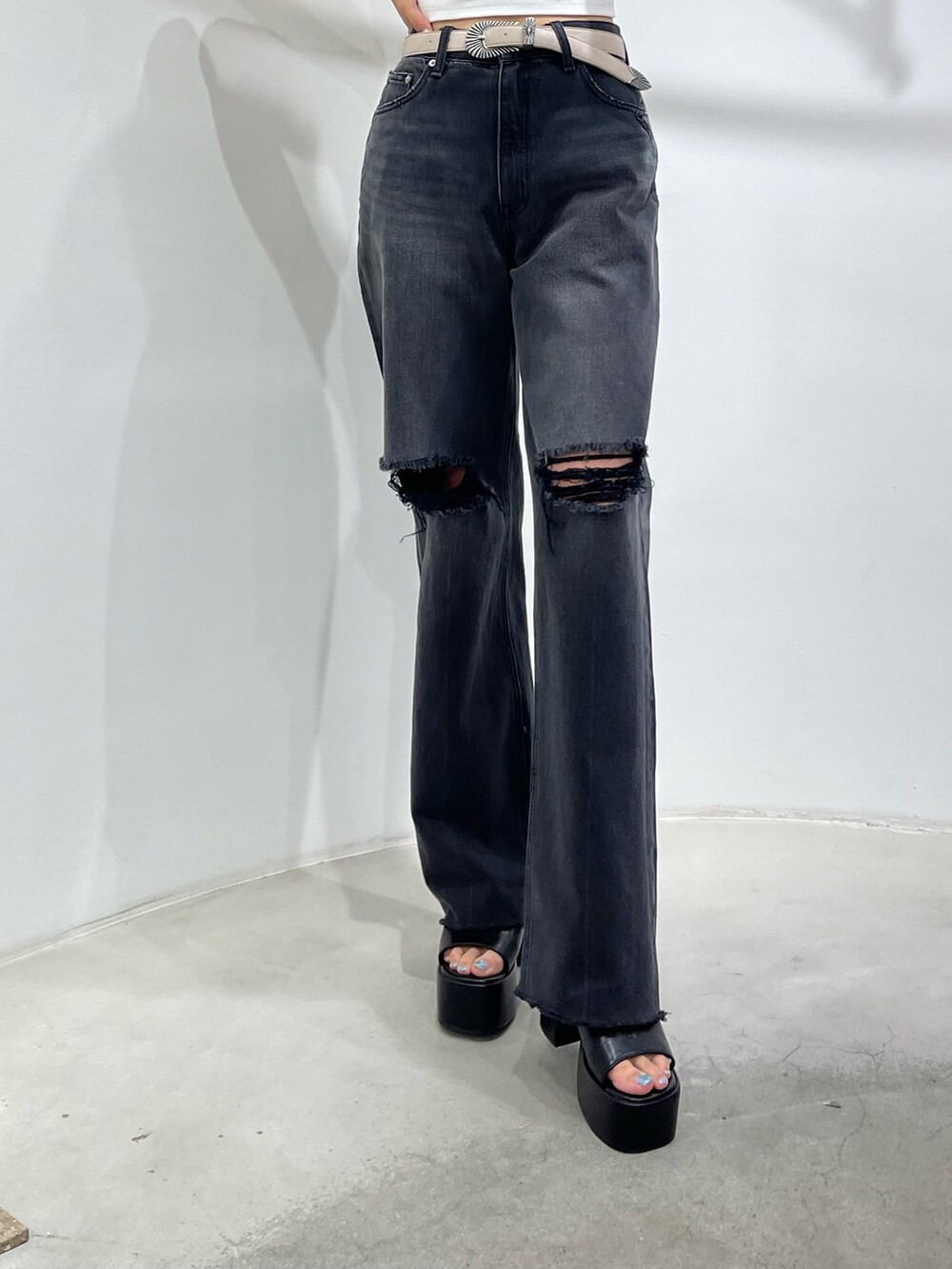 ホワイト系のキャミソール、ブラック系のデニムパンツ、ブラック系のサンダルを着用したレディースの夏コーディネートの6枚目の写真