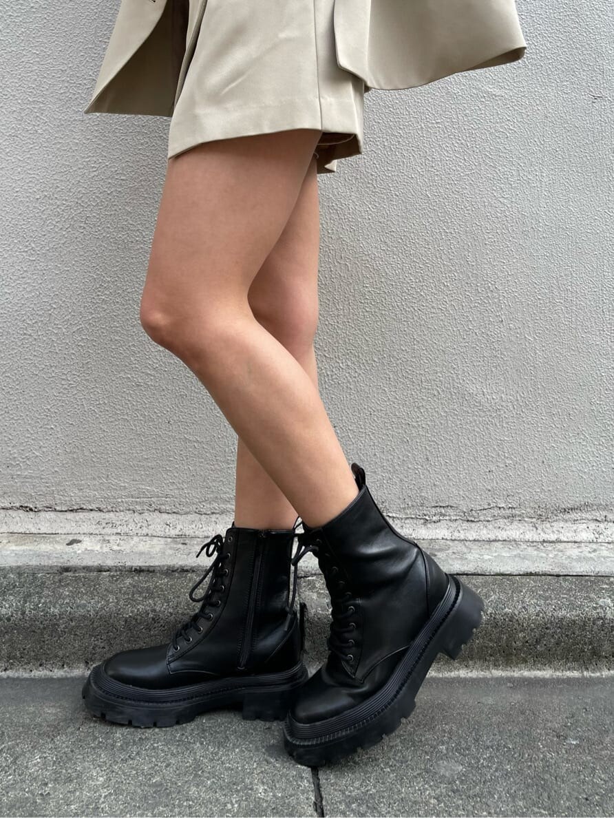 ブラック系のブーツ、ブラック系のキャミソール、ベージュ系のスカートを着用したレディースの春コーディネートの7枚目の写真