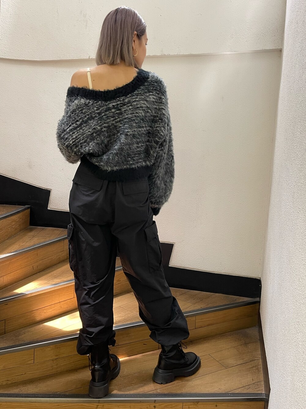 ブラック系のカーゴパンツ、ブラック系のブーツ、ブラック系のカーディガン/ボレロを着用したレディースの秋コーディネートの4枚目の写真