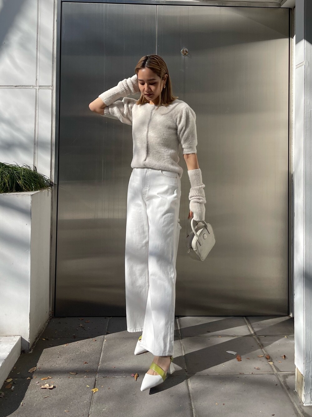 ホワイト系のショルダーバッグ、ホワイト系のサンダル、ホワイト系のニット/セーターを着用したレディースの冬コーディネートの2枚目の写真